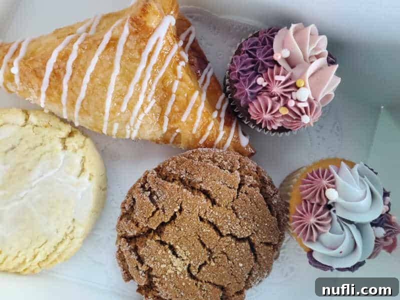 Spokane's Sweetest Spots A Bakery Guide 16 cookies, cupcakes, and scones in a bakery box