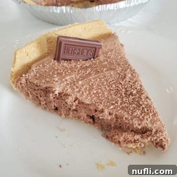 Slice of Hershey no bake pie on a white plate