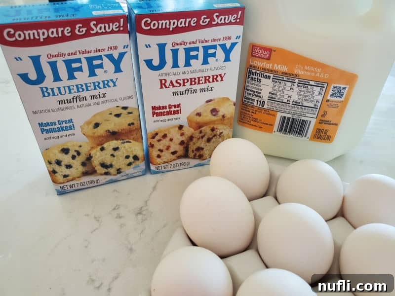 The 3 Ingredient Muffin Mix Pancake Hack 3 Essential ingredients for Muffin Mix Pancakes: a selection of muffin mix boxes, a carton of milk, and fresh eggs, neatly arranged on a kitchen counter.