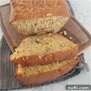 Slices of 3 ingredient banana bread on a wood board