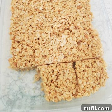 Delicious Peanut Butter Rice Krispie Treats 6 Peanut butter rice Krispie squares in a glass baking dish, ready to be served.