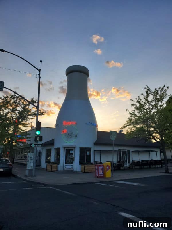 Milk bottle restaurant with clouds behind it