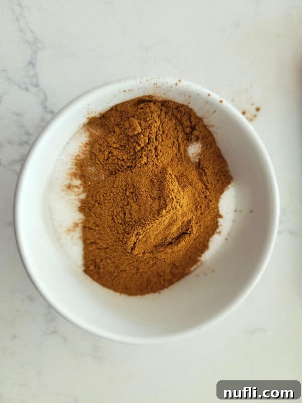 Ground cinnamon and white sugar in a bowl for the perfect cinnamon sugar ratio