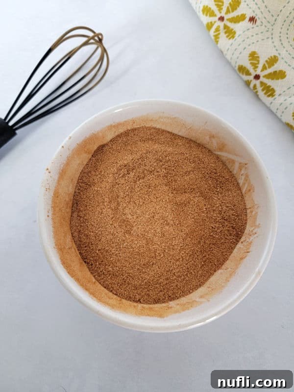 Cinnamon sugar in a white bowl with a whisk