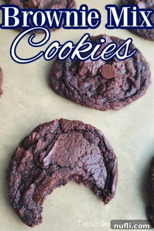 Brownie Mix Cookies text over a parchment lined sheet with cookies with one having a bite out of it