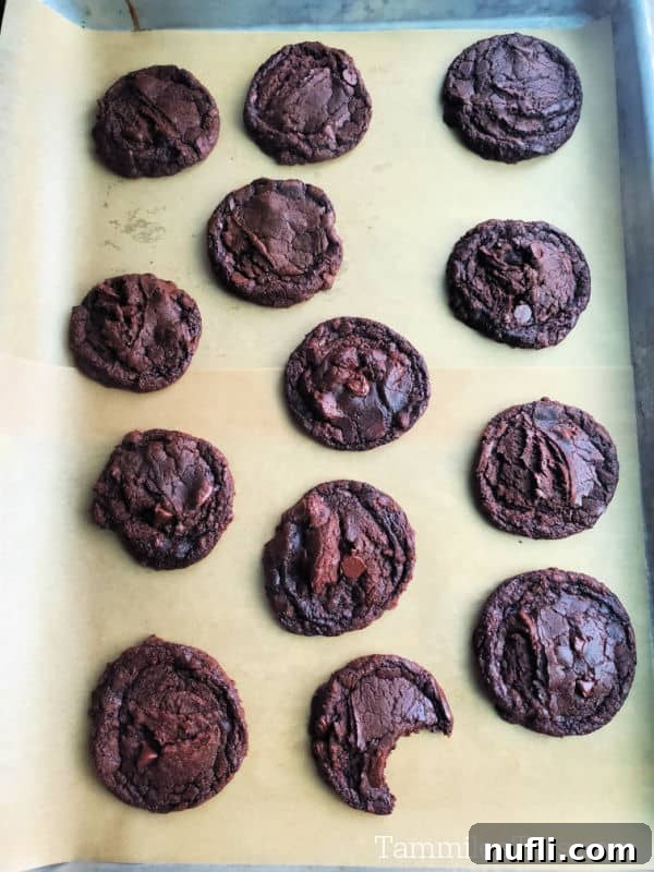 baked brownie cookies on a parchment lined baking sheet