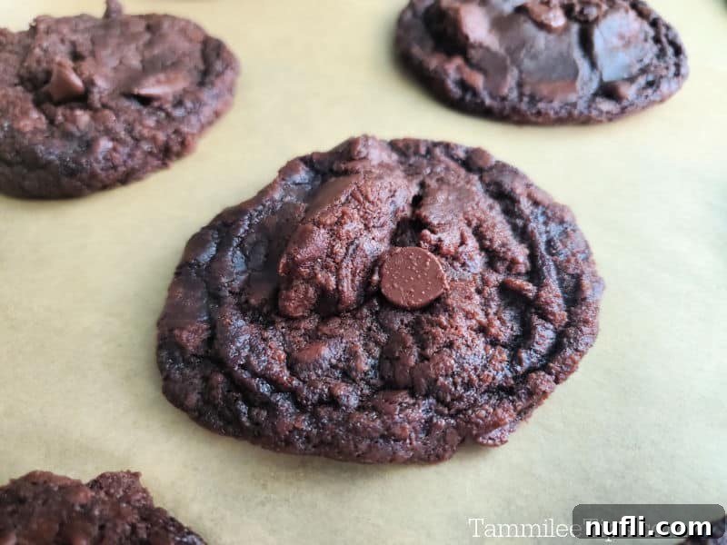 Chocolate brownie cookies lined on parchment paper