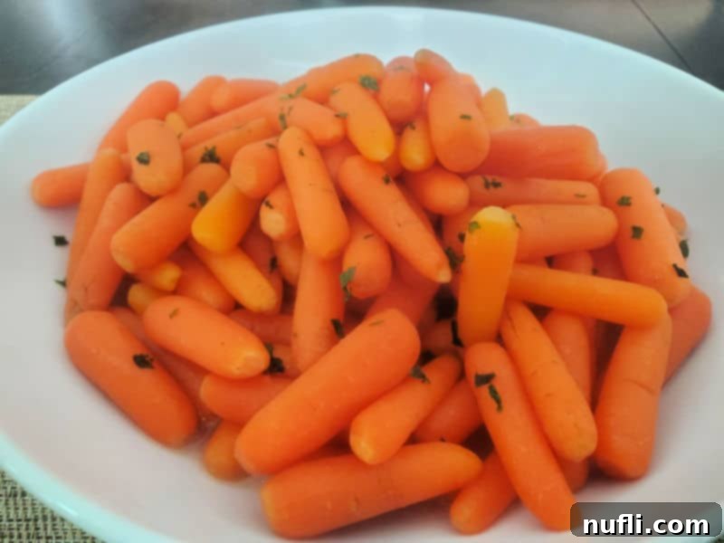 Cracker Barrel Copycat Carrots 7 Cracker Barrel Carrots in a white serving bowl on a dark table