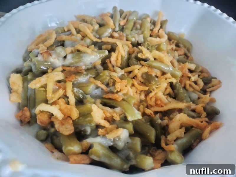 Campbell's Green Bean Casserole in a white serving bowl, a simple and delicious holiday side