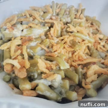 Classic Campbell's Green Bean Casserole with fried onions on top in a white bowl
