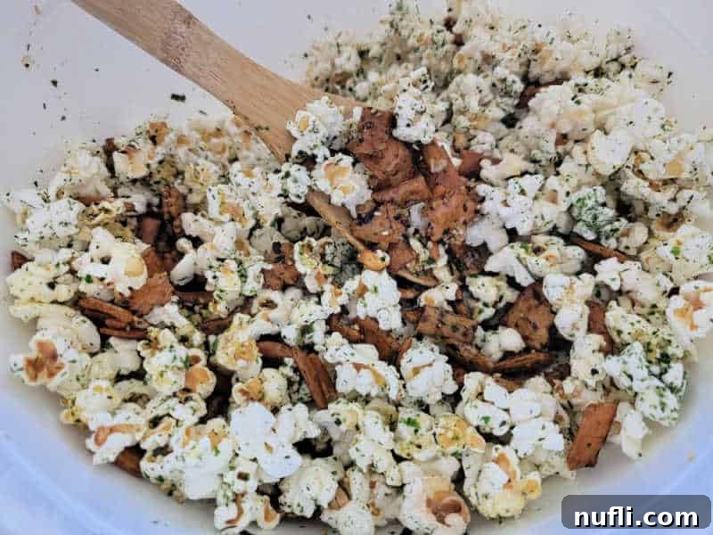 Large white bowl with Hawaiian Hurricane Popcorn and a wooden spoon
