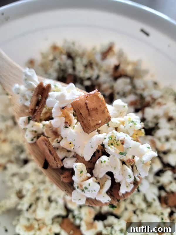 Wooden spoon holding popcorn with Mixed arare and furikake seasoning