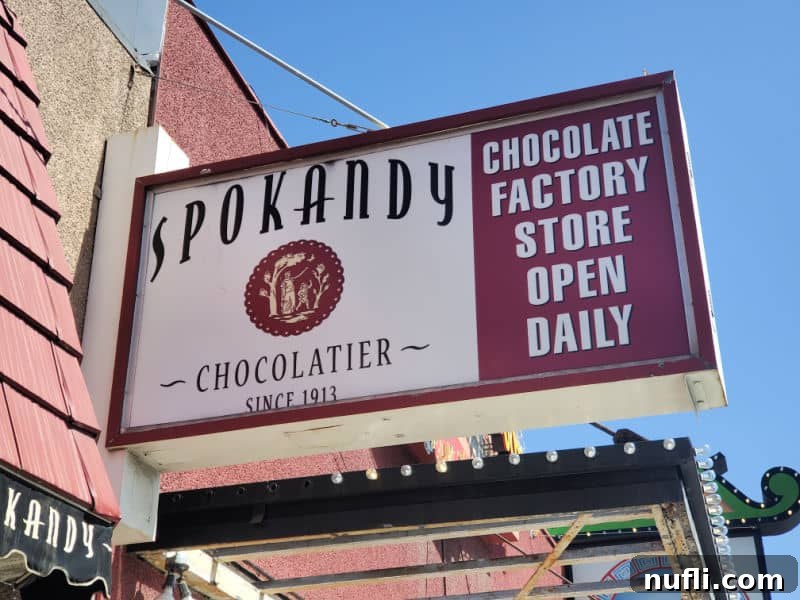 Spokandy sign with chocolate factory store open daily