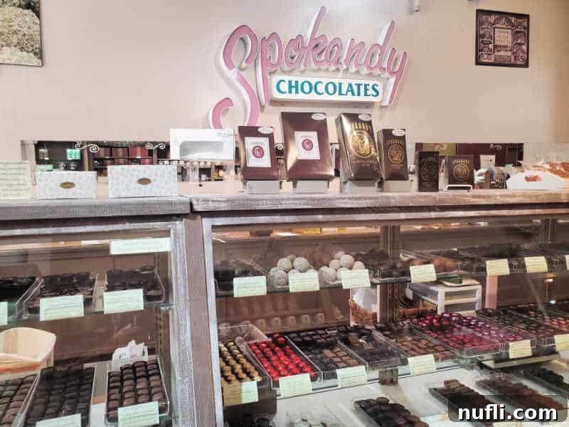 Spokandy chocolate over a glass display case filled with chocolates