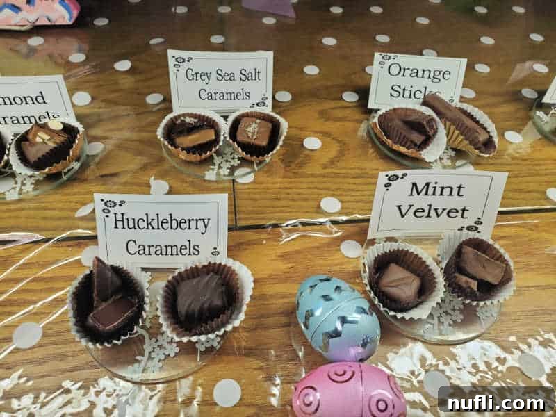 chocolates on display with signs detailing what they are