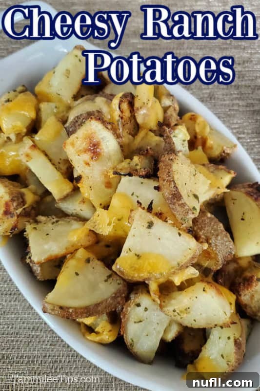 Hidden Valley Ranch Potatoes in a white serving dish with cheese on top of them