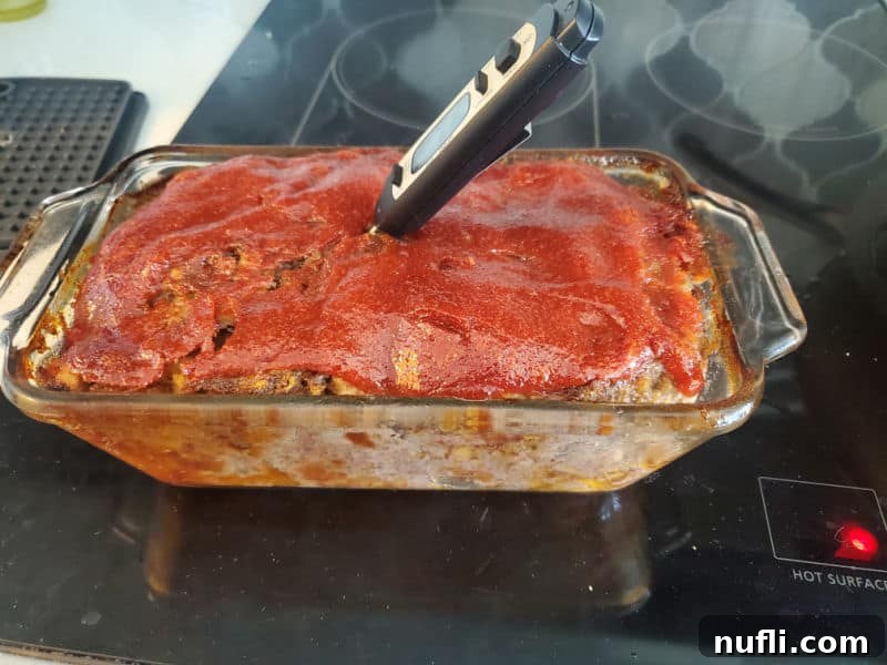 meat thermometer in Stove Top Meatloaf in a glass baking dish. 