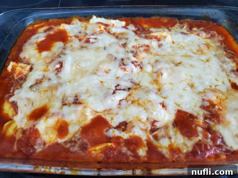 A perfectly baked lazy lasagna in a glass casserole dish, with melted, golden-brown cheese and bubbling sauce.