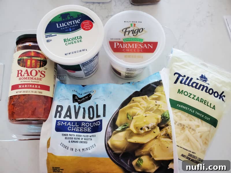Selection of key ingredients for lazy lasagna: Rao's marinara sauce, ricotta cheese, Parmesan cheese, small round frozen ravioli, and Tillamook Mozzarella cheese.