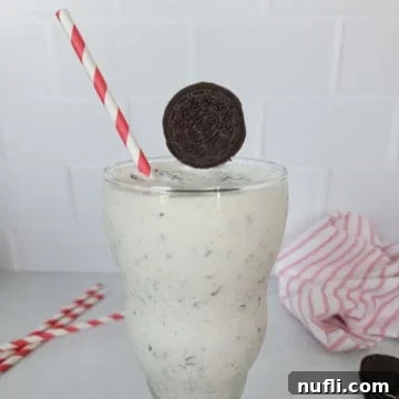 Whip Up a Perfect Oreo Milkshake 6 Oreo Milkshake Recipe in a shake glass with a red striped straw