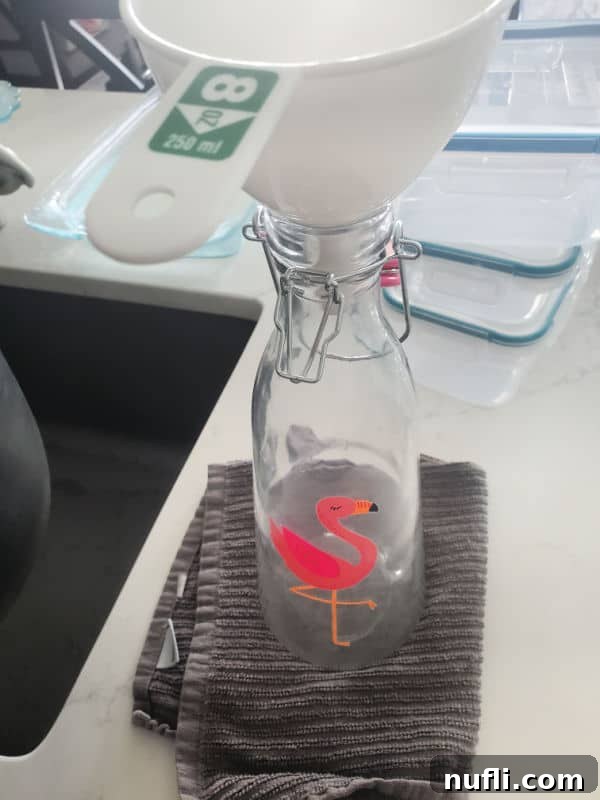 Recreate Starbucks Passion Tea Lemonade 4 Funnel in the top of a flamingo pitcher.