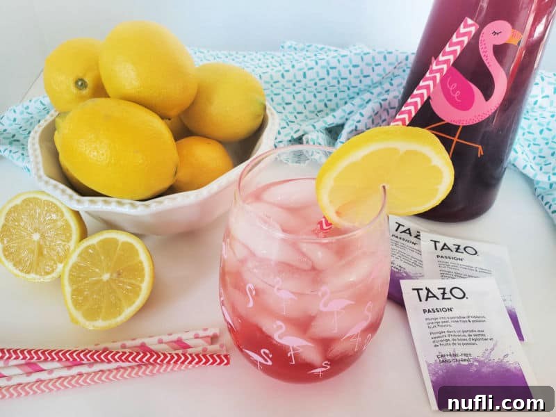 Recreate Starbucks Passion Tea Lemonade 6 Copycat Starbucks Passion Tea Lemonade in a mason jar next to Tazo Passion tea bags, and a bowl of lemons