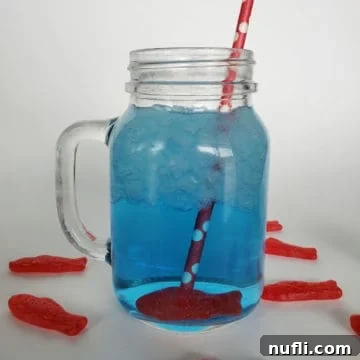 Sonic ocean water in a mason jar with a Swedish fish candy and red straw