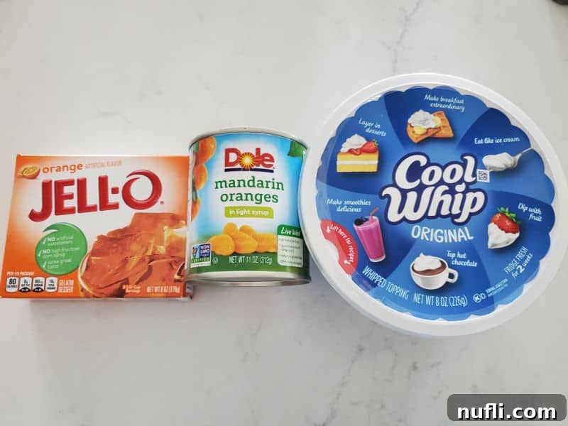 orange jello box, mandarin oranges, and cool whip on a marble counter 
