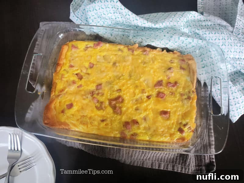 ham and egg crescent roll in a baking dish next to a cloth napkin 