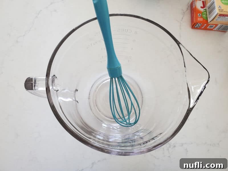 blue whisk in a glass bowl