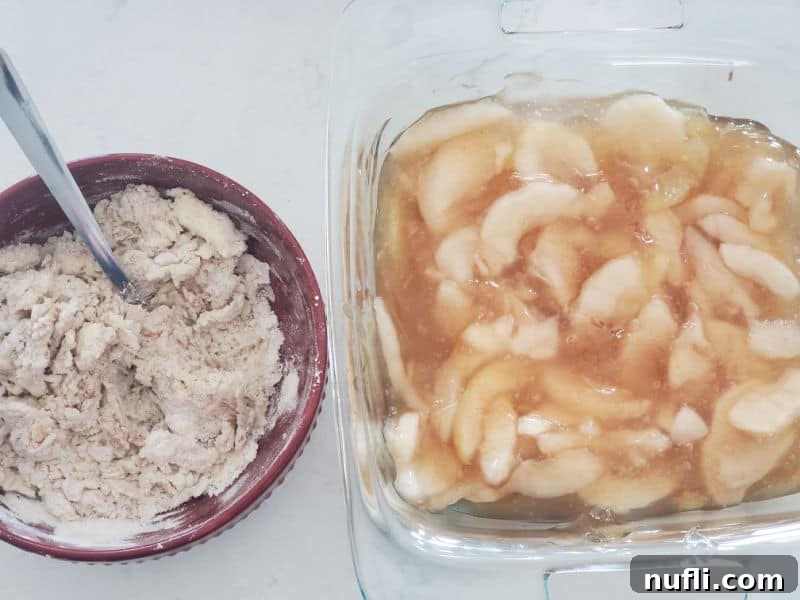 Easy Bisquick Apple Cobbler 6 Bowl with cobbler mix and a spoon next to a glass baking dish with apples