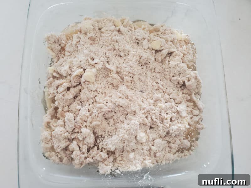 Easy Bisquick Apple Cobbler 7 Cobbler topping in a glass baking dish