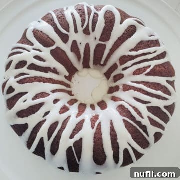 Mountain Dew Cake on a white platter, ready to be served, showcasing its golden-brown crust and inviting texture.