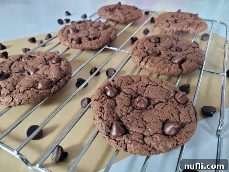 More Devils Food chocolate cake mix cookies on a wire rack, glistening with melted chocolate from chocolate chips.