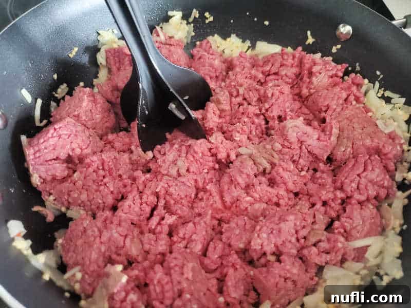 mix n chop in ground beef and onion in a skillet