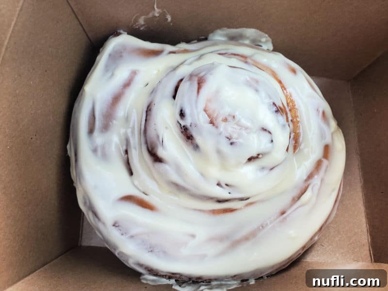 Giant cinnamon roll in brown cardboard box from Books and Bites Roslyn