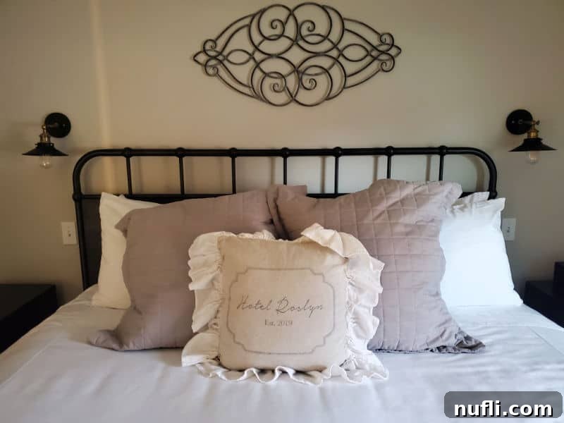 Hotel Roslyn guest bed with wrought iron frame, and Hotel Roslyn Pillow