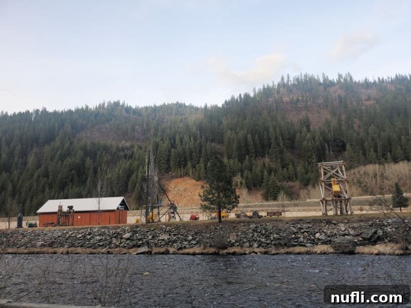 minig heritage exhibition seen across the river with a hill and trees in the background 