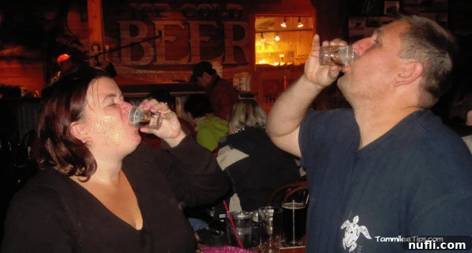 Crafting the Perfect Duck Fart Shot 4 Tammilee and John enjoying Duck Fart shots, looking cheerful and warm on a cold Alaskan night.