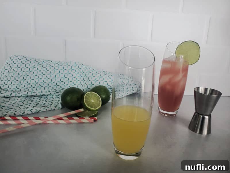 The first step of making a Bay Breeze cocktail: pouring vodka into a highball glass, with a cocktail jigger next to it.
