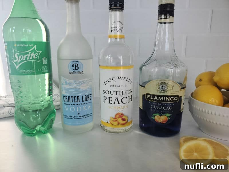 Sprite, Vodka, Peach Schnapps, Blue curacao bottles next to a bowl of lemons