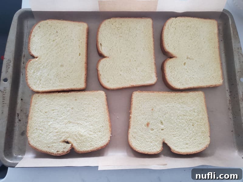 bread slices arranged on a parchment lined baking sheet