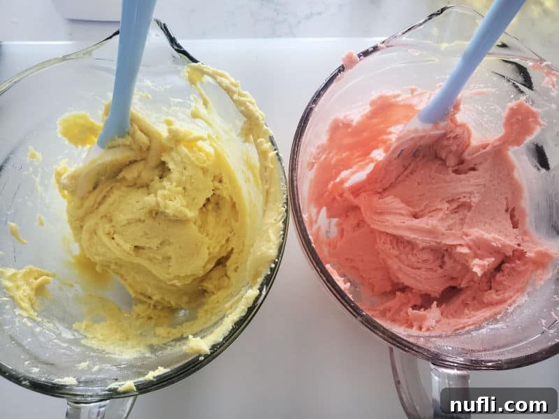 Separate bowls of lemon cake cookie dough and strawberry cake cookie dough, ready for swirling.