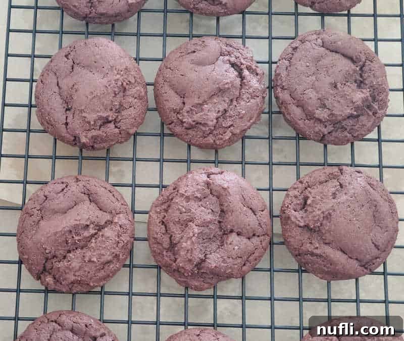 Decadent Texas Sheet Cake Cookies 5 Texas sheet cake chocolate cookies on a drying rack, covered in a glossy chocolate icing
