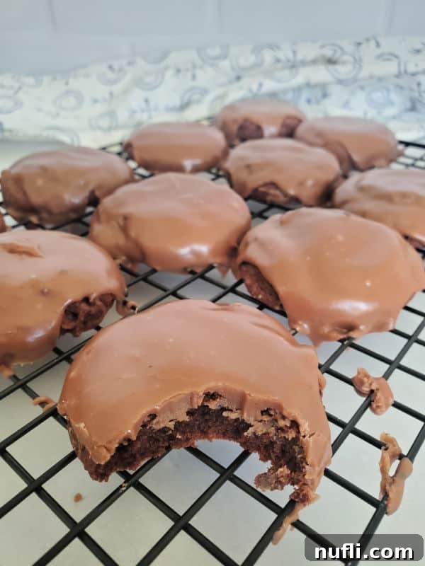 Texas sheet cake cookies on a drying rack with a bite taken out of a cookie