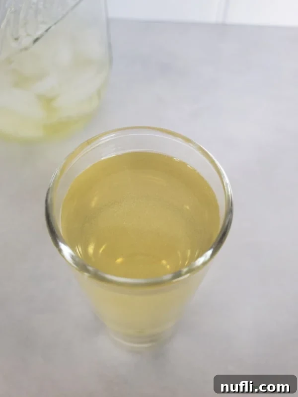 Close up of the top of a Green Tea Shot in a clear glass shot glass. 