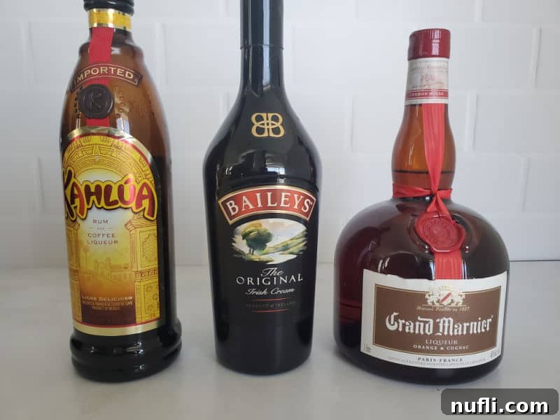 Crafting the B52 Shot A Video Guide 3 Bottles of Kahlua Coffee Liqueur, Bailey's Irish Cream, and Grand Marnier Orange Liqueur, the three essential ingredients for a B52 shot.
