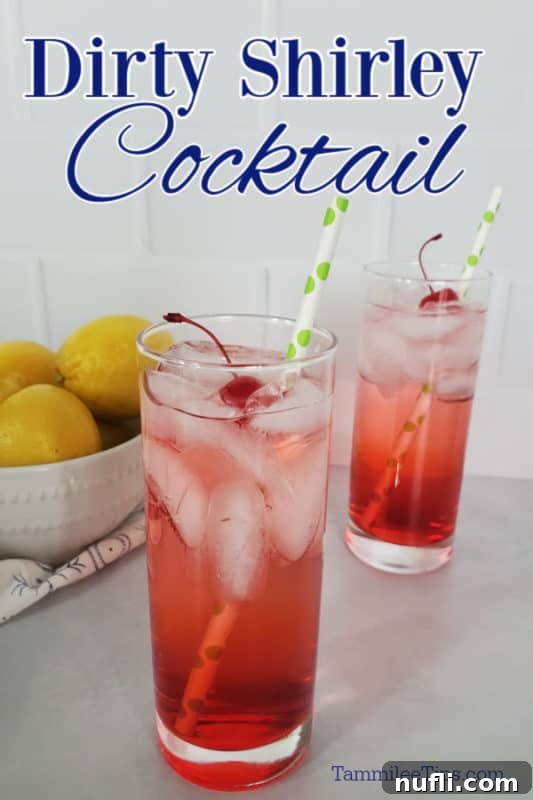 Dirty Shirley Cocktail text over two glasses with red drinks, maraschino cherries, and paper straws next to a bowl of lemons