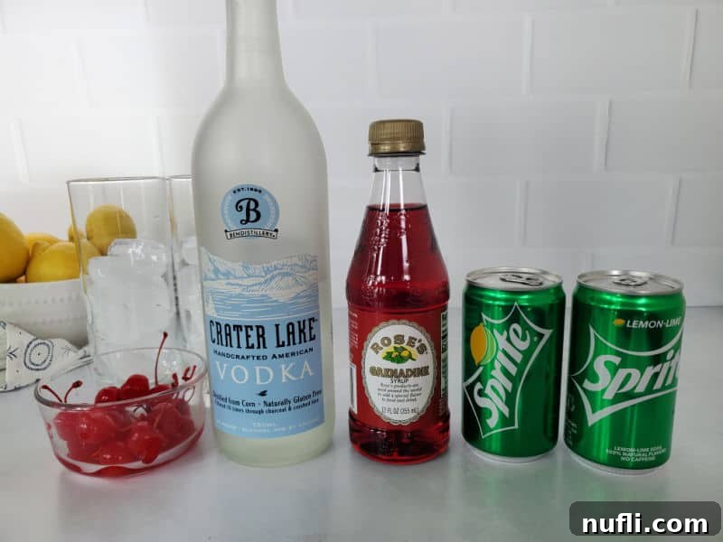 Bowl of lemons, two tall glasses with ice, bowl of maraschino cherries, vodka, rose's grenadine, and two cans of sprite next to each other. 