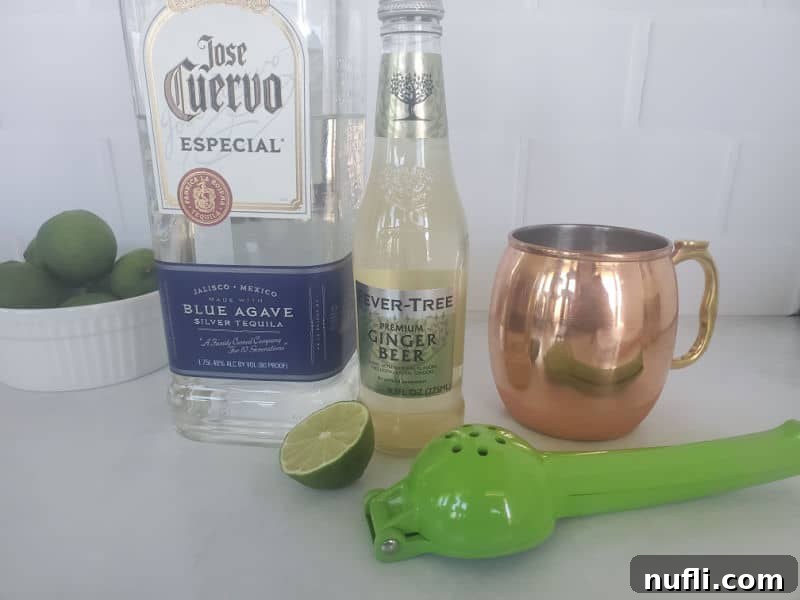 Ingredients for Mexican Mule: Jose Cuervo silver tequila, ginger beer, lime, and a copper mule mug